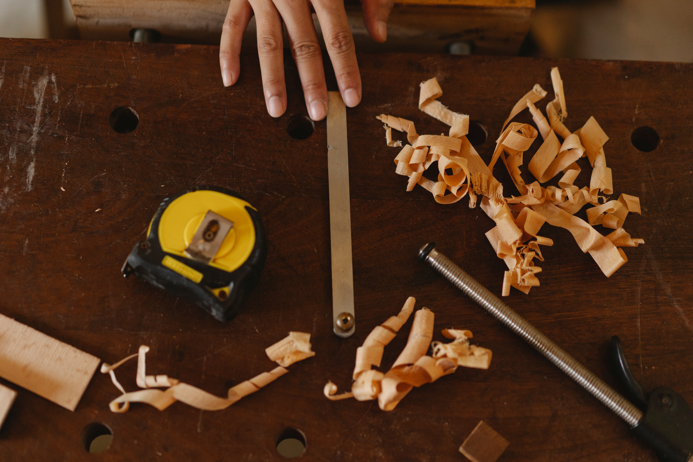 Crop artisan near carpentry tools on workbench